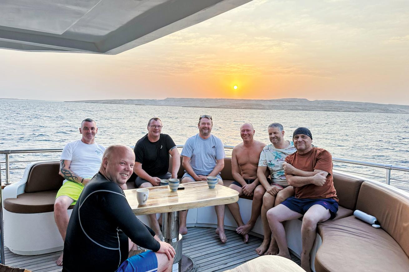 men on a boat at sunrise
