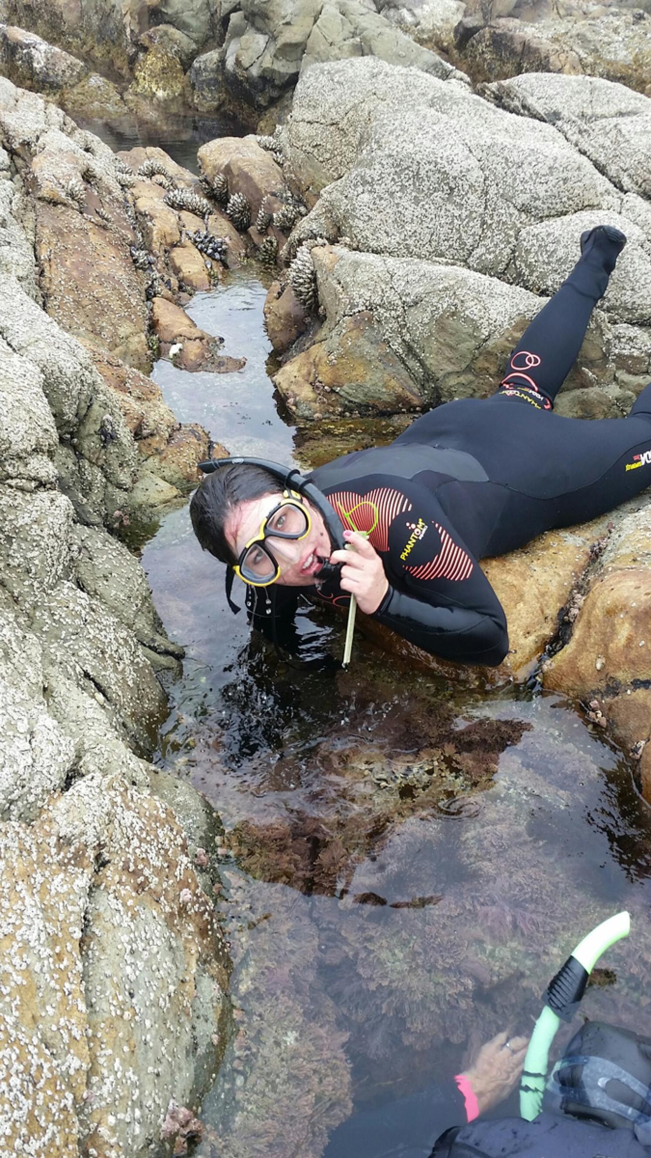 A Get Inspired volunteer surveys a tide pool for baby green abalone