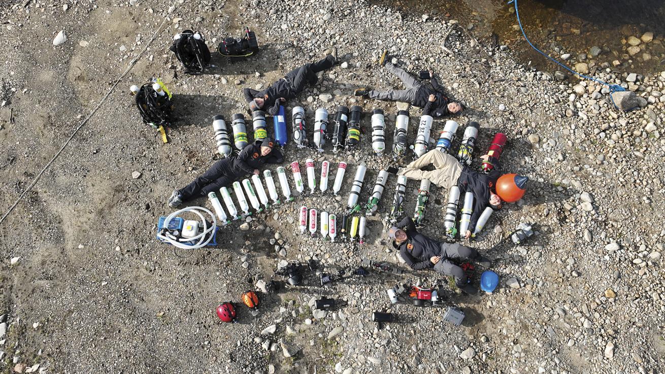 Lasselin and a team of divers pose with an array of diving gear during a 2023 expedition to Manicouagan Crater.