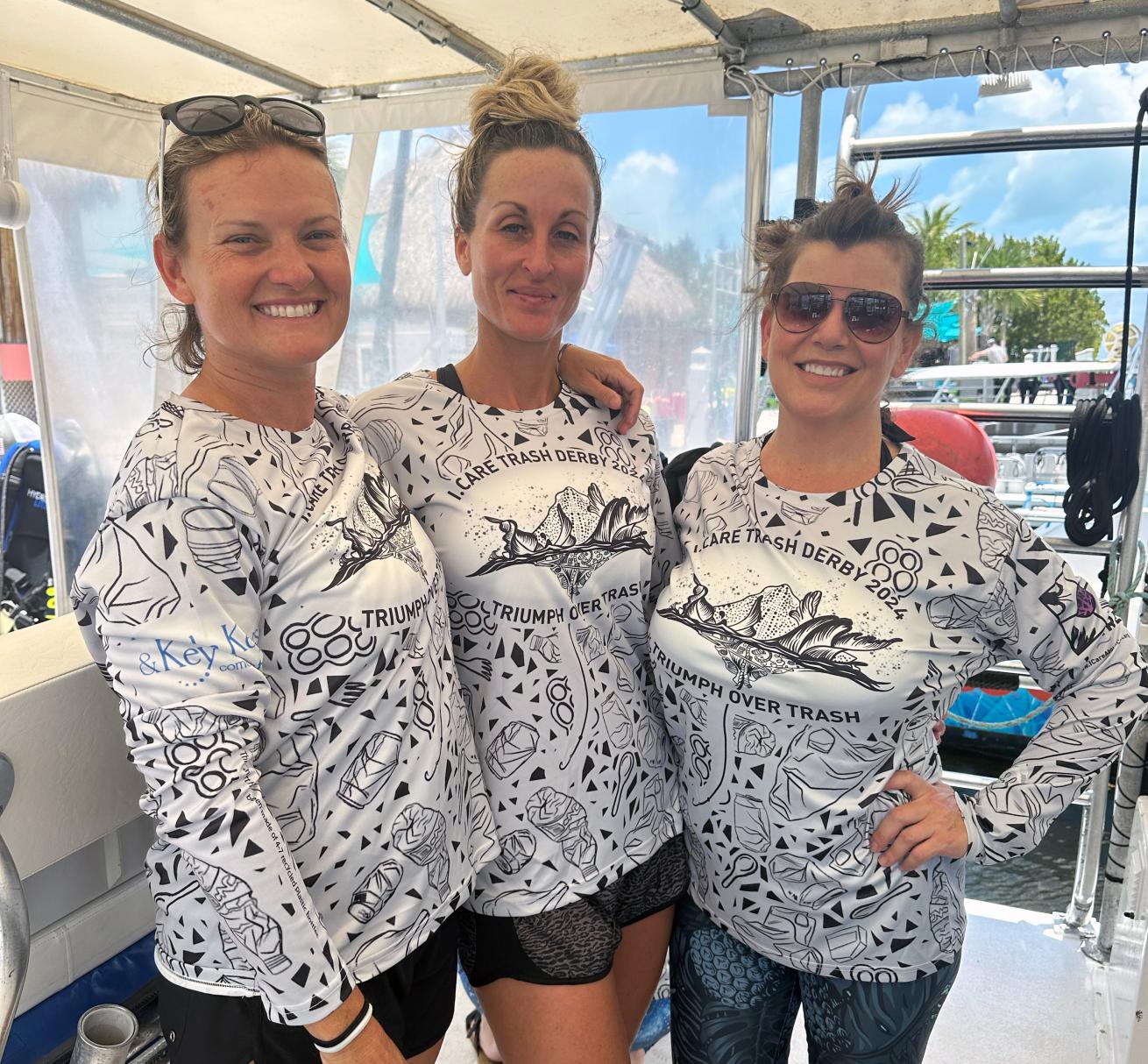 people pose with tshirts from the 2nd annual trash derby in key largo