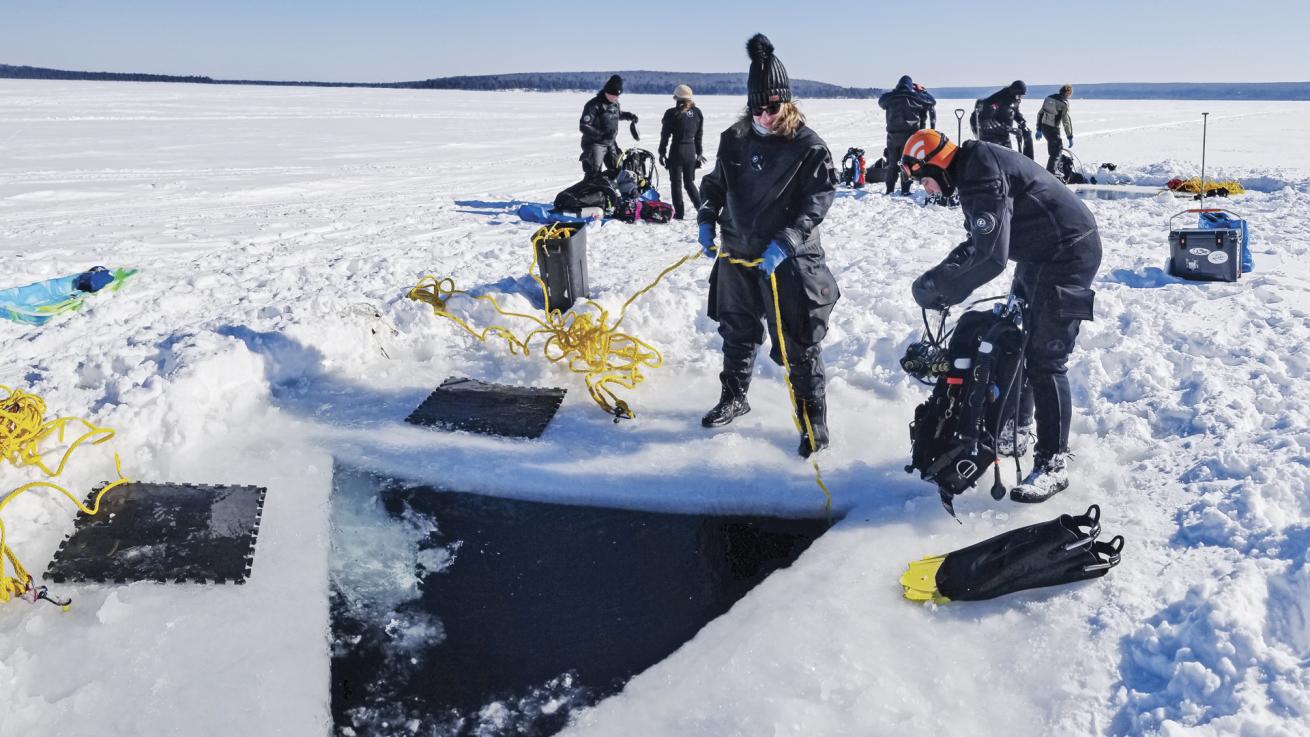 Tenders on the surface are integral to the safety of divers tethered under the ice of Michigan’s lakes.