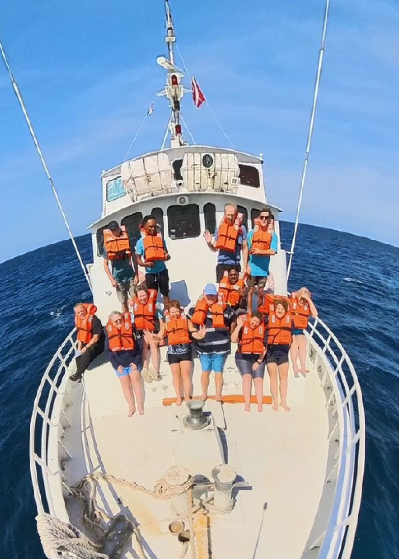 People practicing a safety drill on a boat 